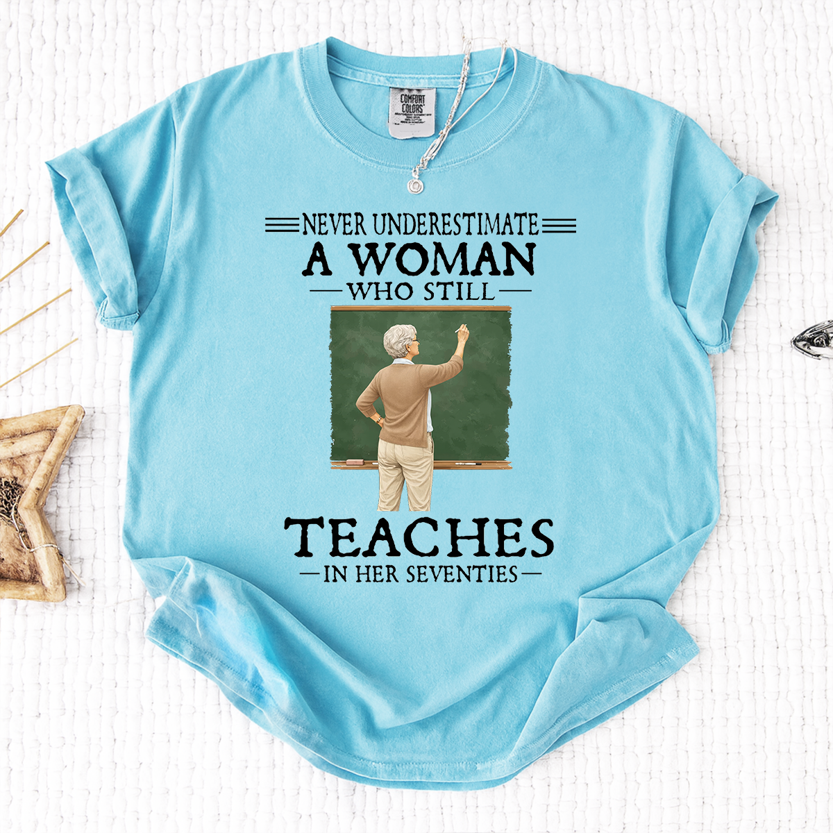 Comfort Colors Never Underestimate A Woman Who Still Teaches in Her Seventies T-Shirt – Custom Gift for Teachers