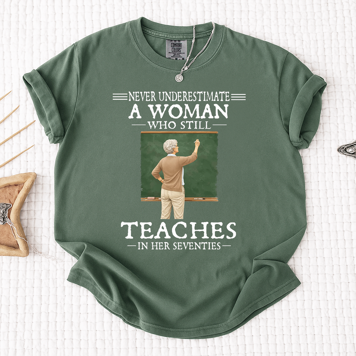 Comfort Colors Never Underestimate A Woman Who Still Teaches in Her Seventies T-Shirt – Custom Gift for Teachers
