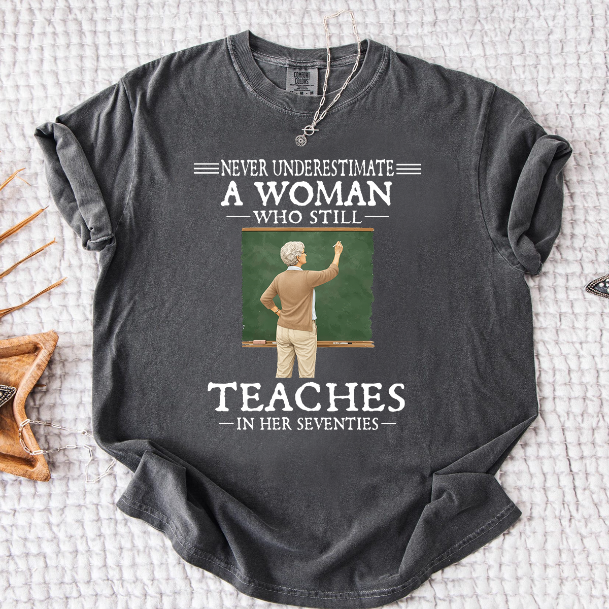 Comfort Colors Never Underestimate A Woman Who Still Teaches in Her Seventies T-Shirt – Custom Gift for Teachers
