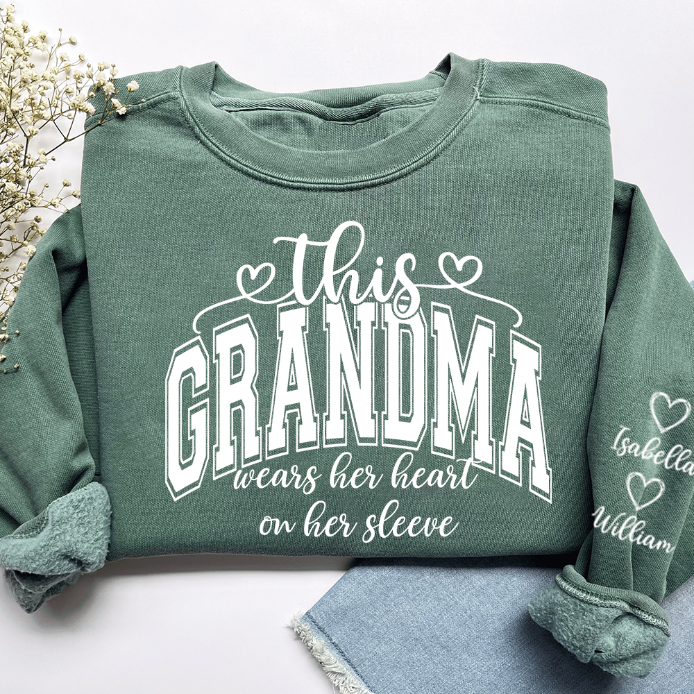 Personalized Grandma Sweatshirt - This Grandma Wears Her Heart On Her Sleeve, Custom Grandkids Names on Sleeve, Cozy Crewneck Sweater Gift for Grandma, Nana, Gigi, Mimi, Family Apparel
