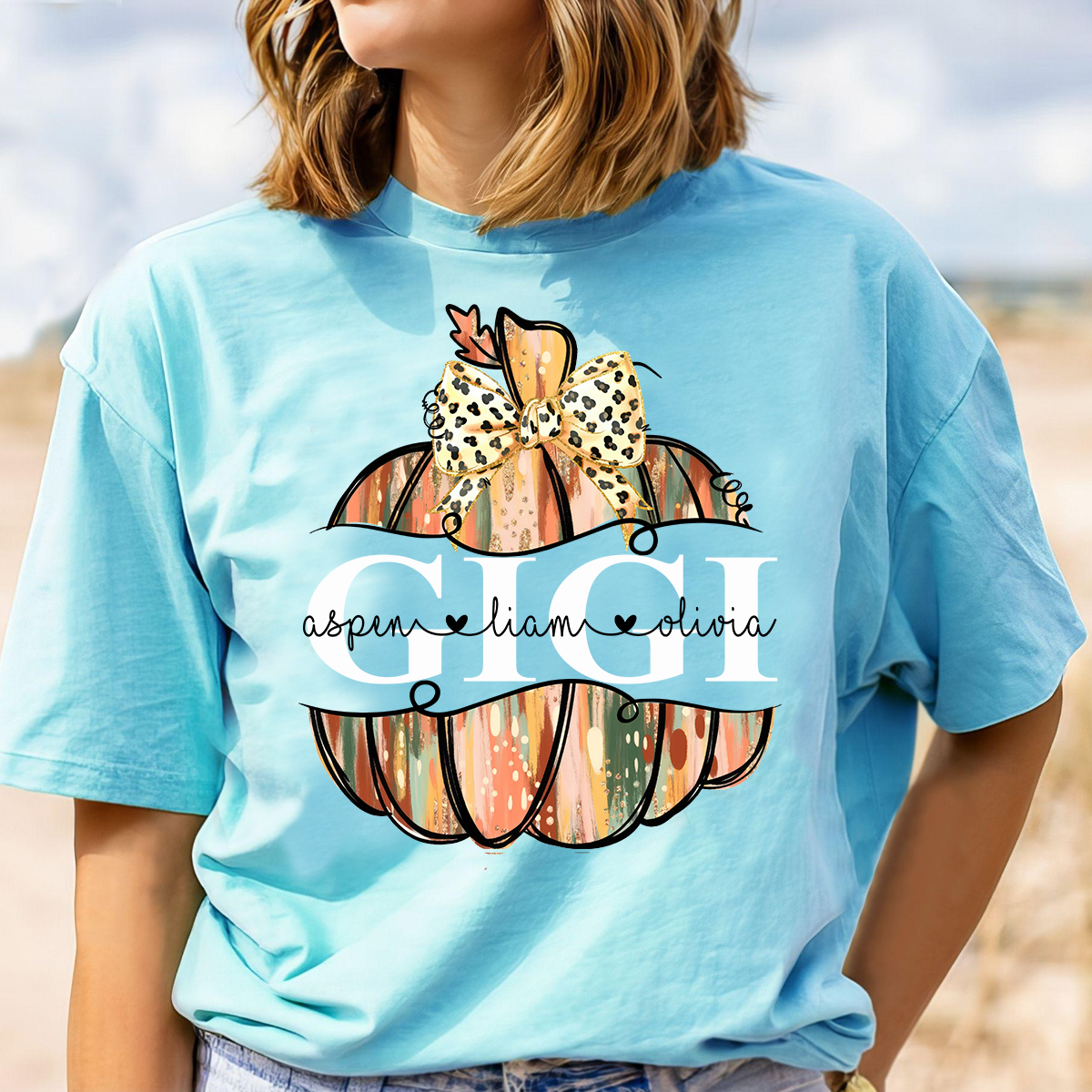 Comfort Colors® Personalized Gigi Pumpkin T-Shirt with Grandkids’ Names, Custom Fall Leopard Bow Tee for Grandma