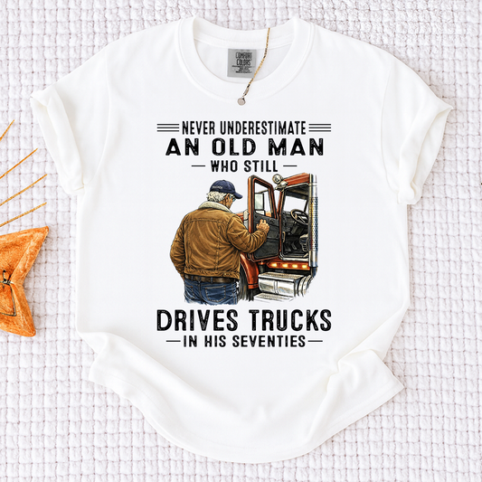 Comfort Colors Never Underestimate An Old Man Who Still Drives Trucks T-Shirt – Custom Gift for Truck Drivers in Their Seventies