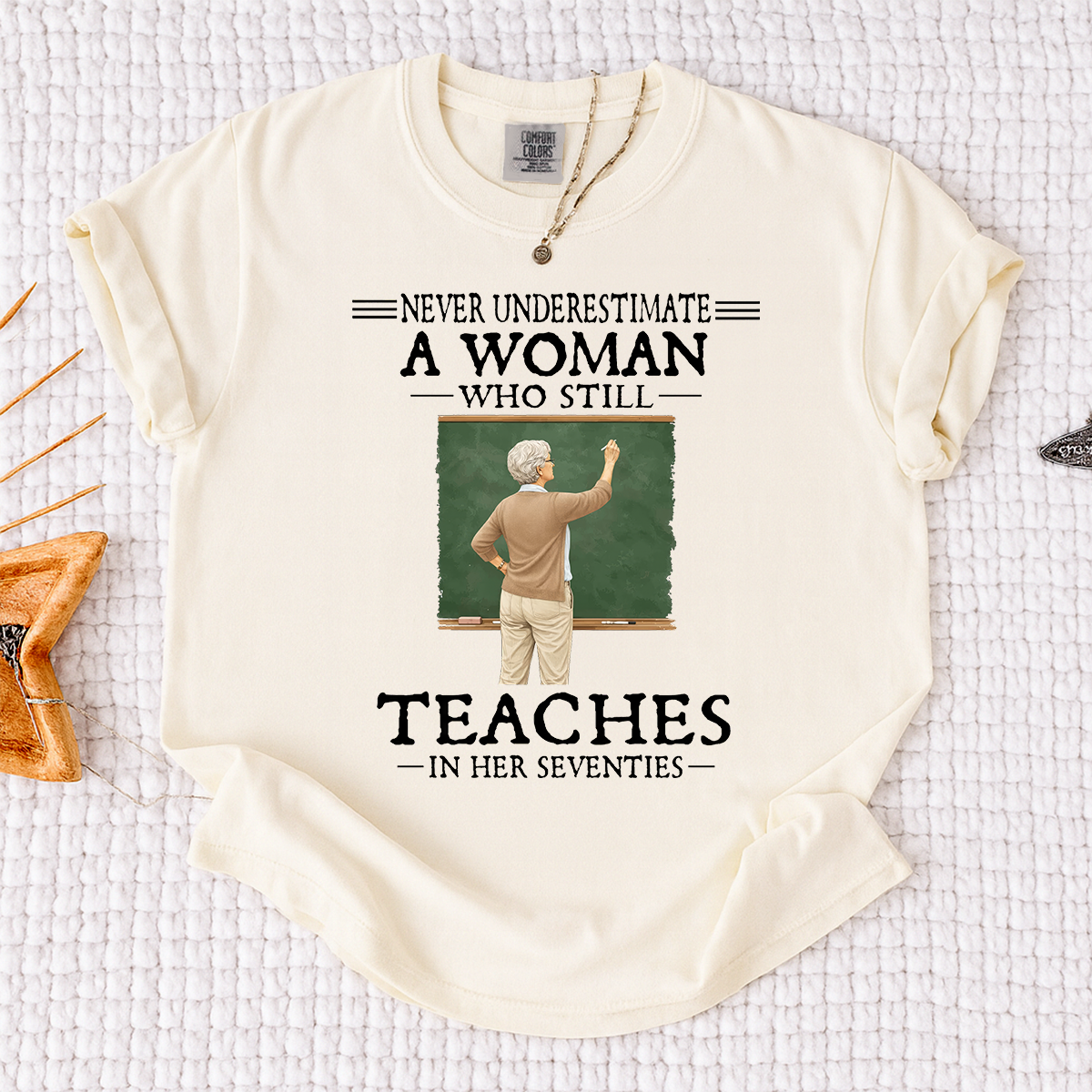Comfort Colors Never Underestimate A Woman Who Still Teaches in Her Seventies T-Shirt – Custom Gift for Teachers