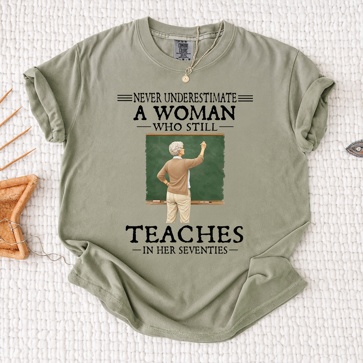 Comfort Colors Never Underestimate A Woman Who Still Teaches in Her Seventies T-Shirt – Custom Gift for Teachers