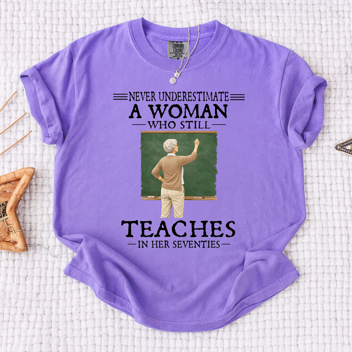 Comfort Colors Never Underestimate A Woman Who Still Teaches in Her Seventies T-Shirt – Custom Gift for Teachers