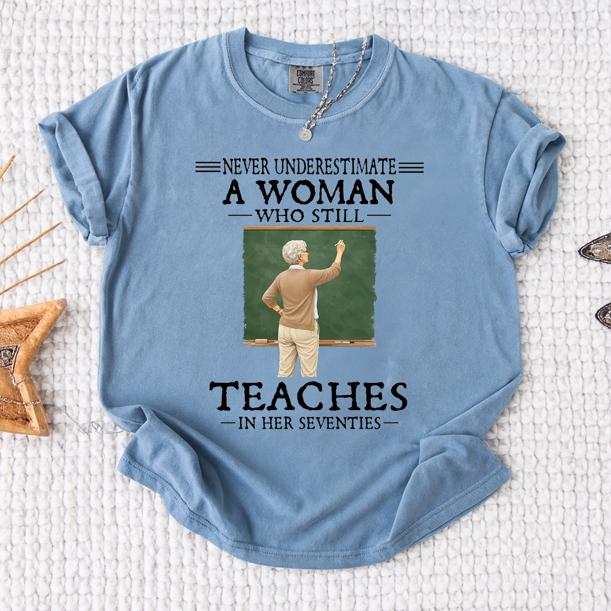 Comfort Colors Never Underestimate A Woman Who Still Teaches in Her Seventies T-Shirt – Custom Gift for Teachers
