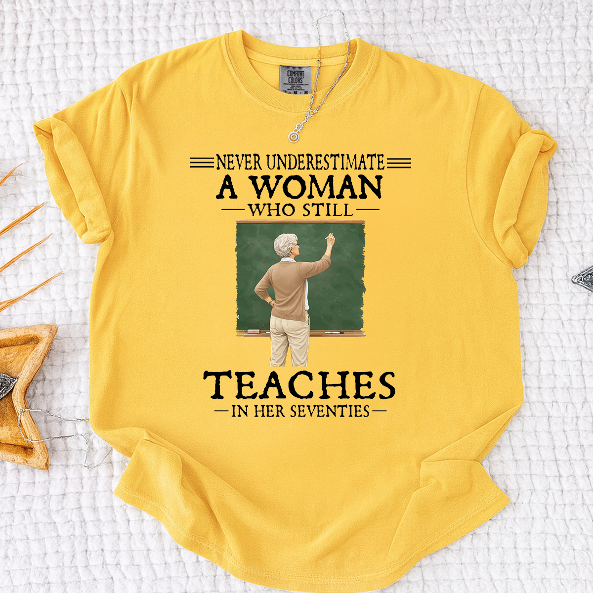 Comfort Colors Never Underestimate A Woman Who Still Teaches in Her Seventies T-Shirt – Custom Gift for Teachers