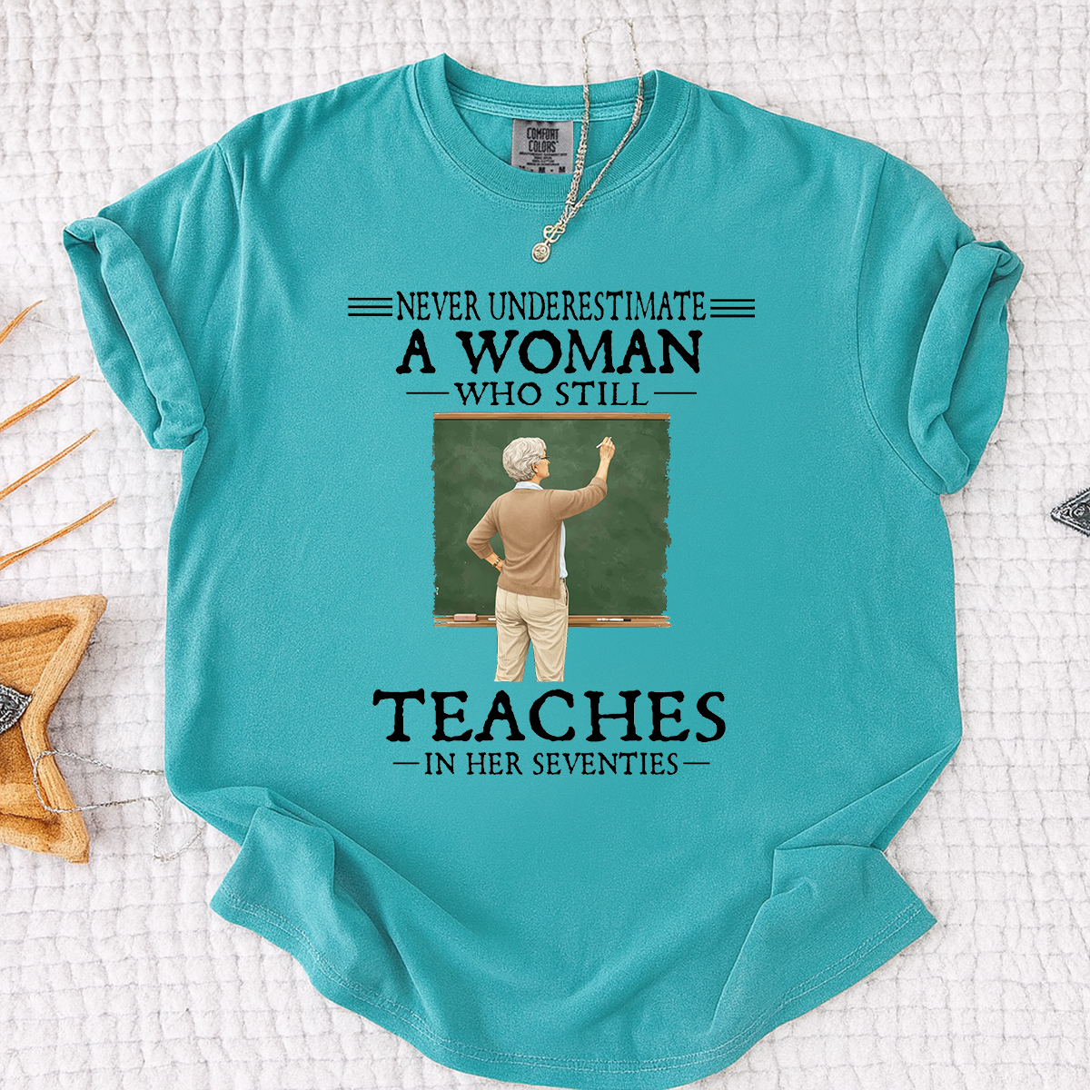 Comfort Colors Never Underestimate A Woman Who Still Teaches in Her Seventies T-Shirt – Custom Gift for Teachers