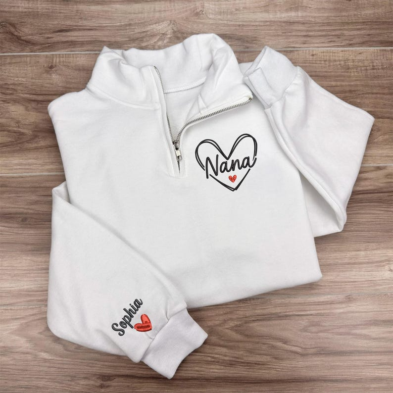 Personalized Nana Quarter Zip Sweatshirt with Heart Design & Custom Grandkids’ Names on Sleeve – Gift for Grandma